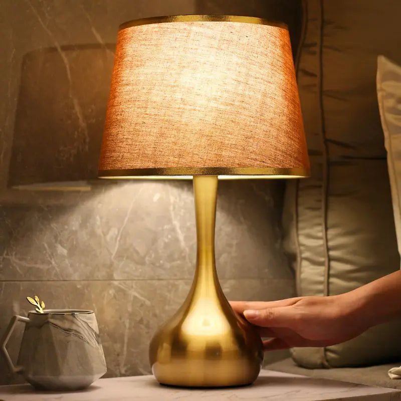 Sophisticated table lamp Luminis with gold metal base and fabric shade in cosy ambiance – view 4