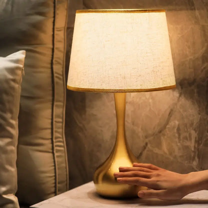 Sophisticated table lamp Luminis with gold metal base and fabric shade in cosy ambiance – view 5